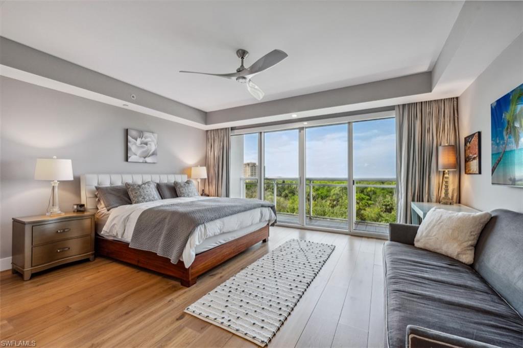 13915 Old Coast Road, Unit 504 Naples, FL 34110 - Photo 16 of 41 a bedroom with a large bed and a couch