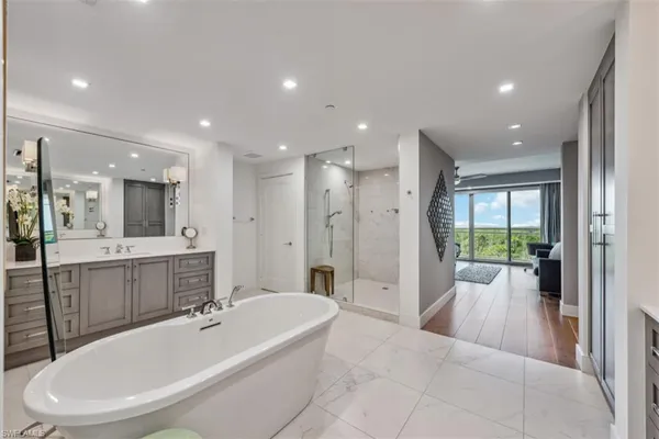a bathroom with a tub shower and sink