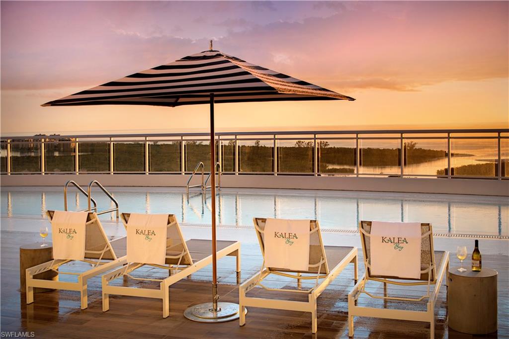 13915 Old Coast Road, Unit 504 Naples, FL 34110 - Photo 22 of 41 a view of a chairs and table on the terrace