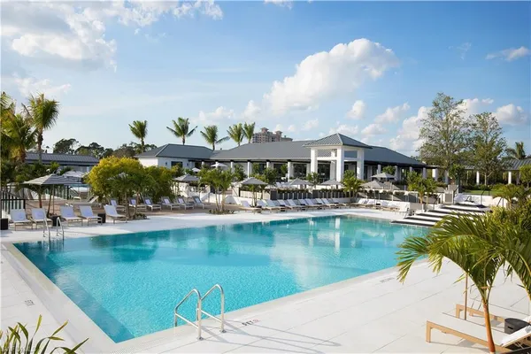 a view of swimming pool with outdoor seating and garden