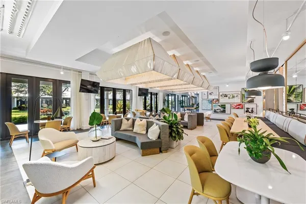 a living room with patio furniture and a floor to ceiling window
