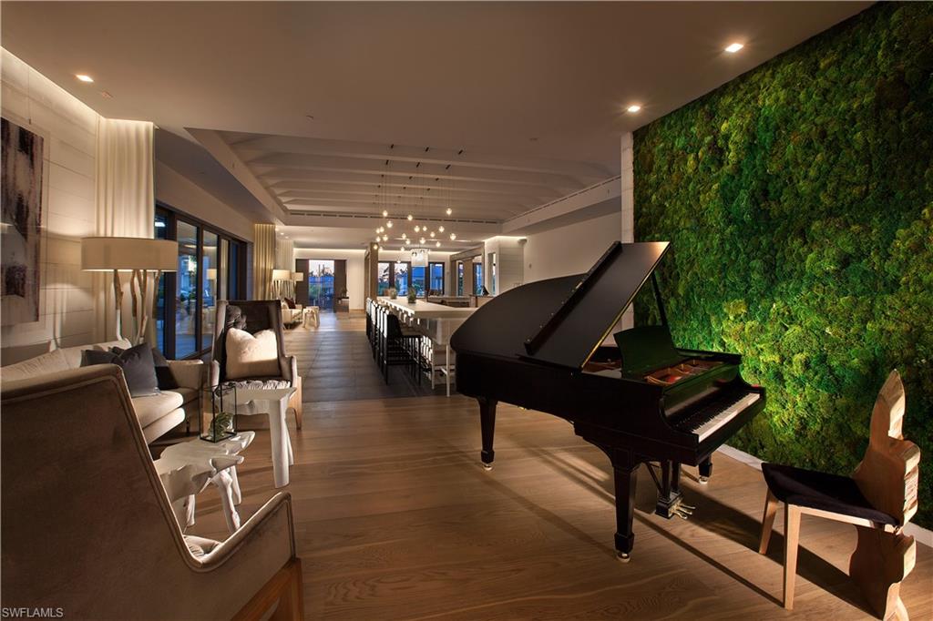 13915 Old Coast Road, Unit 504 Naples, FL 34110 - Photo 38 of 41 a living room with furniture and a potted plant