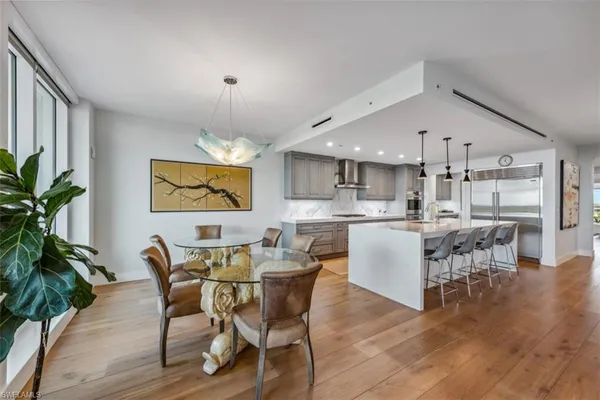 a dining room with furniture and wooden floor