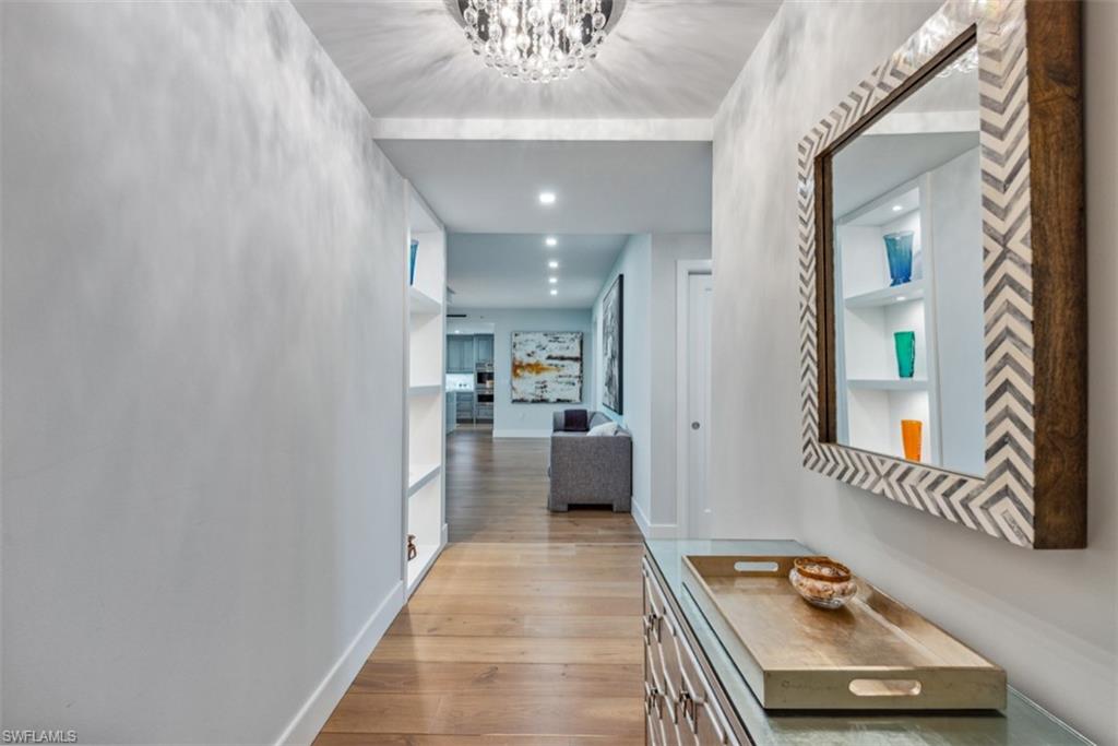 13915 Old Coast Road, Unit 504 Naples, FL 34110 - Photo 9 of 41 a room with furniture and a chandelier