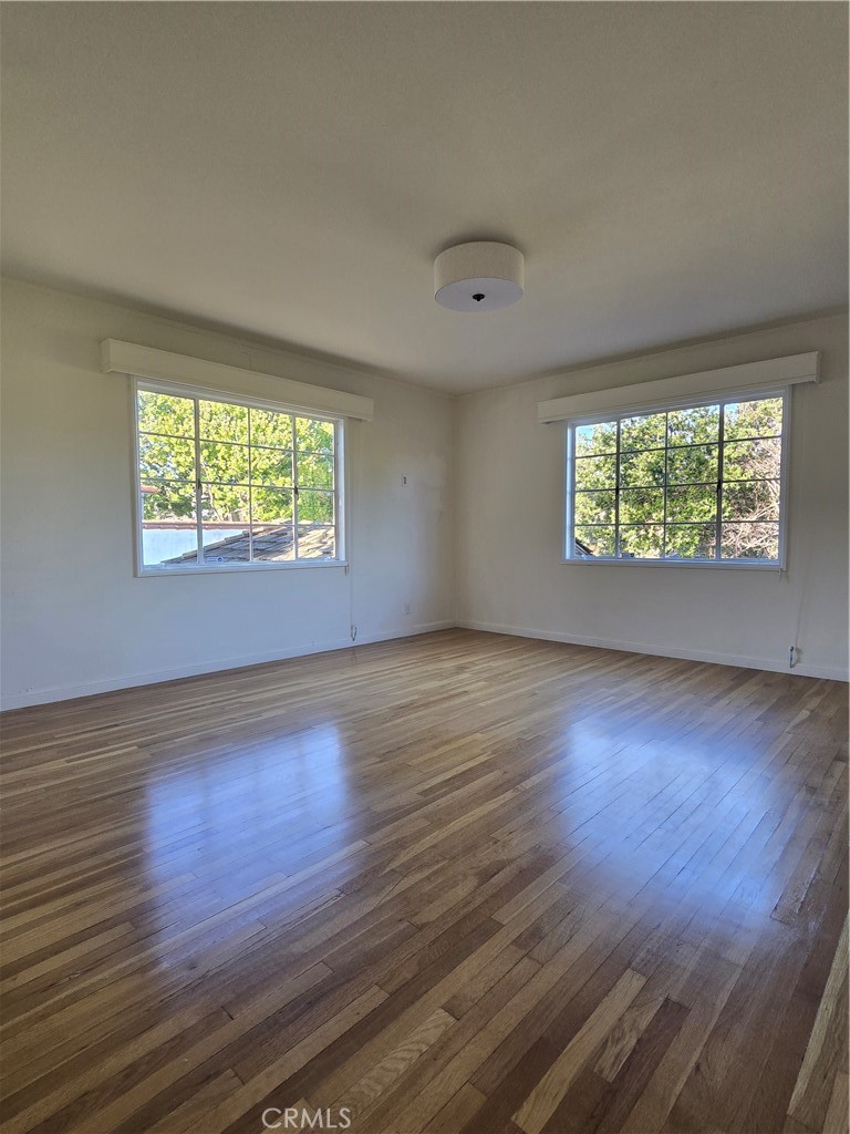 1868 St Albans Road San Marino, CA 91108 - Photo 11 of 15 an empty room with wooden floor and windows