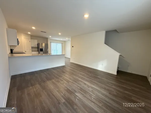 a view of a kitchen with wooden floor and a sink