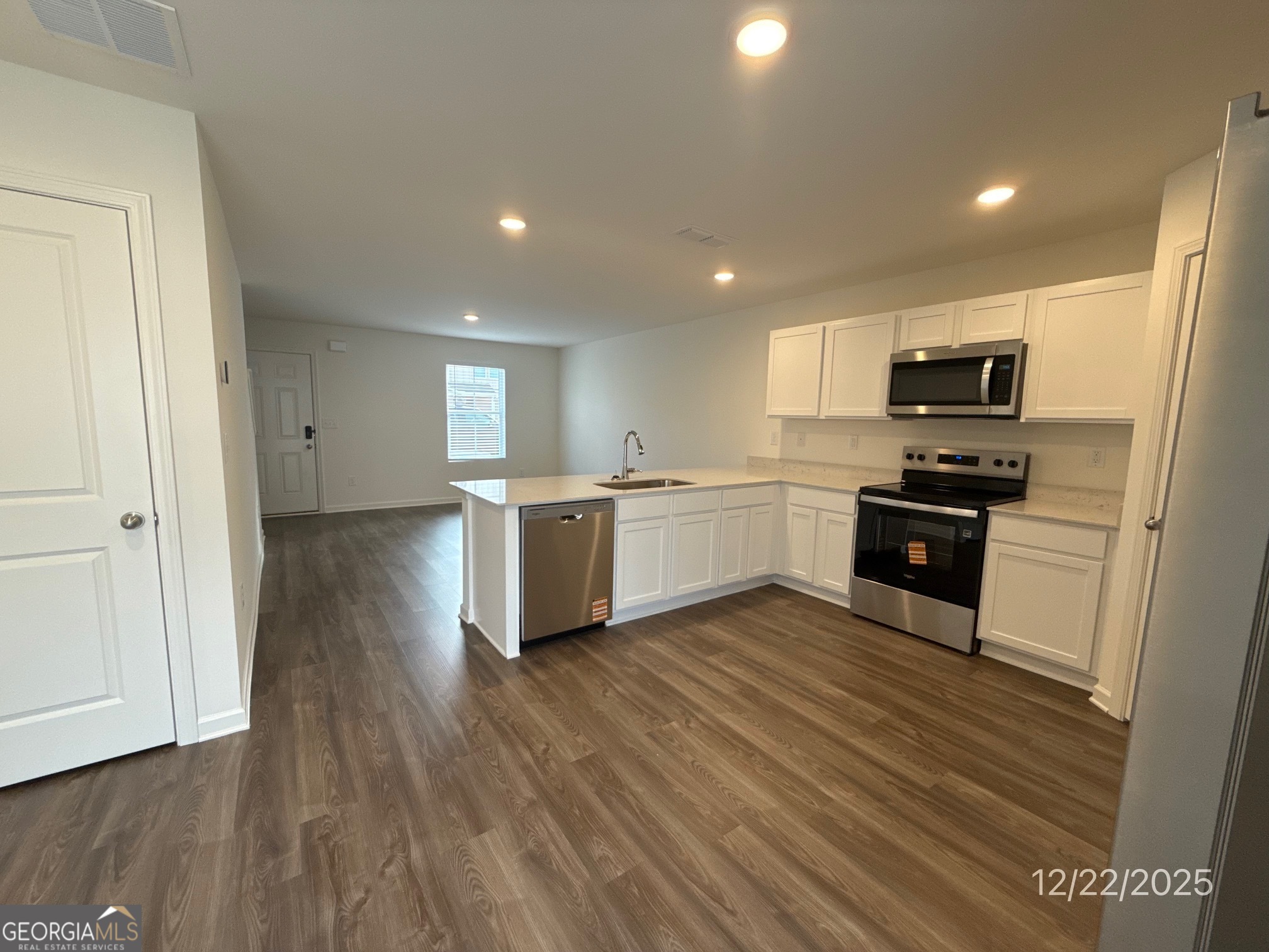 489 Grand Magnolia Street Jackson, GA 30233 - Photo 5 of 19 a kitchen with a refrigerator and a stove top oven