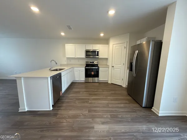 a kitchen with stainless steel appliances granite countertop a refrigerator stove and oven