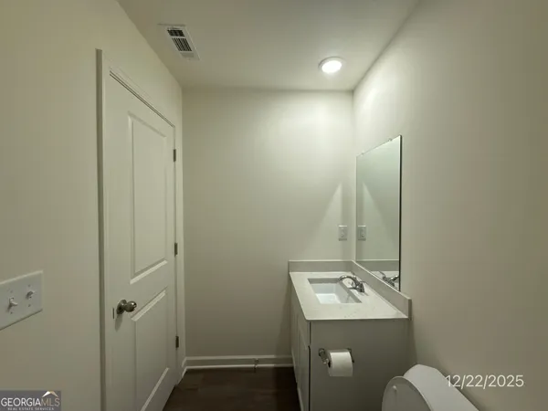 a bathroom with a sink a toilet and mirror