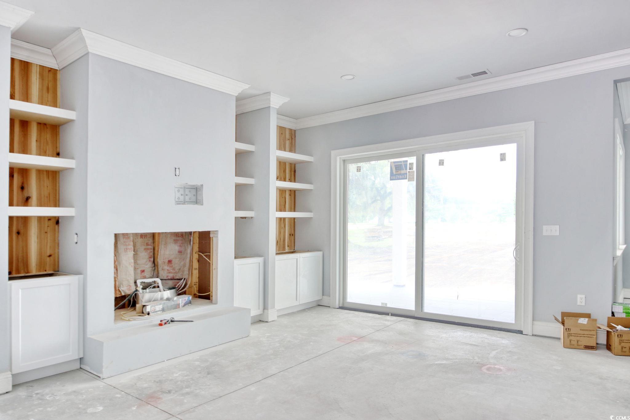 105 Michau Road Georgetown, SC 29440 - Photo 12 of 32 Unfurnished living room with concrete floors, orna
