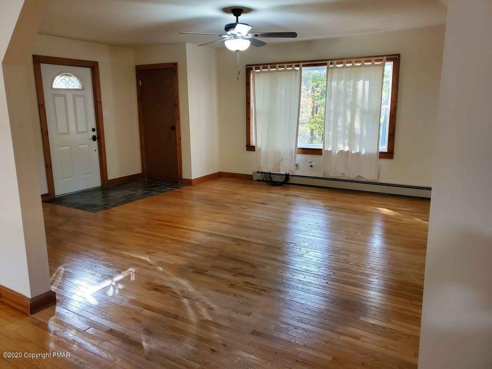 1615 Silver Maple Road Effort, PA 18330 - Photo 7 of 13 a view of an empty room with wooden floor and a window
