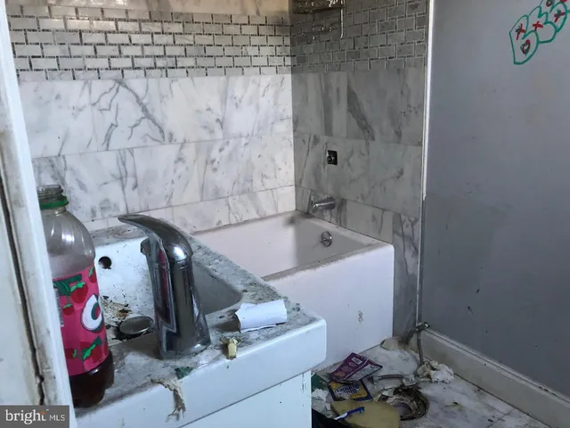 a bathroom with a bathtub and shower