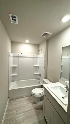 a kitchen with a refrigerator stove and white cabinets