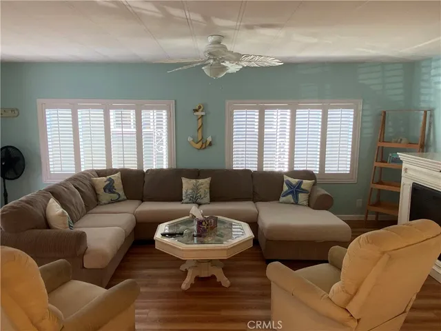 a living room with furniture a fireplace and a window