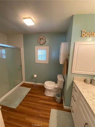a bathroom with a sink mirror vanity and toilet