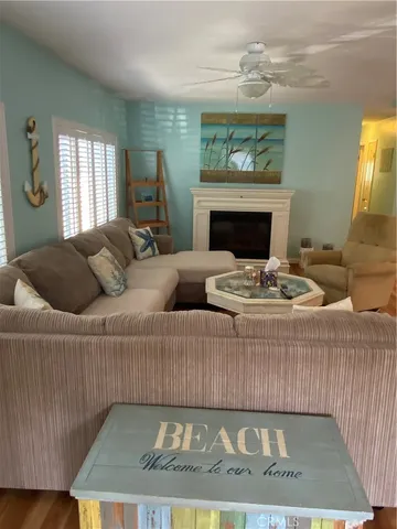 a living room with furniture a fireplace and a chandelier