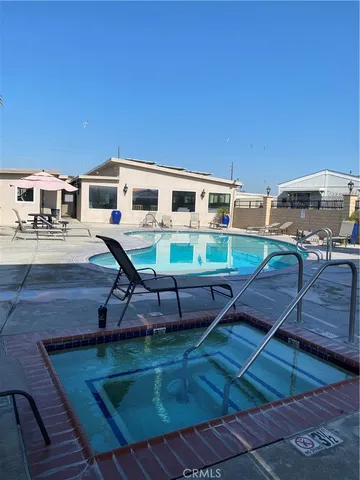 a view of a house with pool and chairs