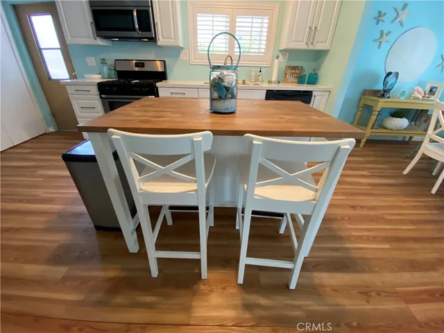 a kitchen with a dining table chairs and entryway
