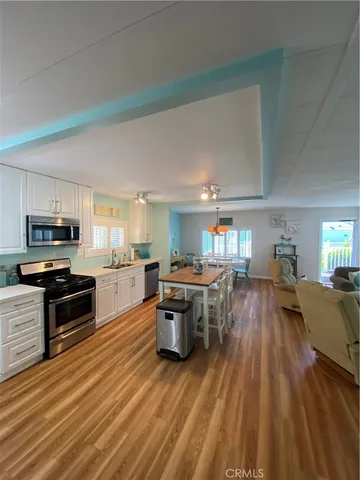 a kitchen with a sink and wooden floor