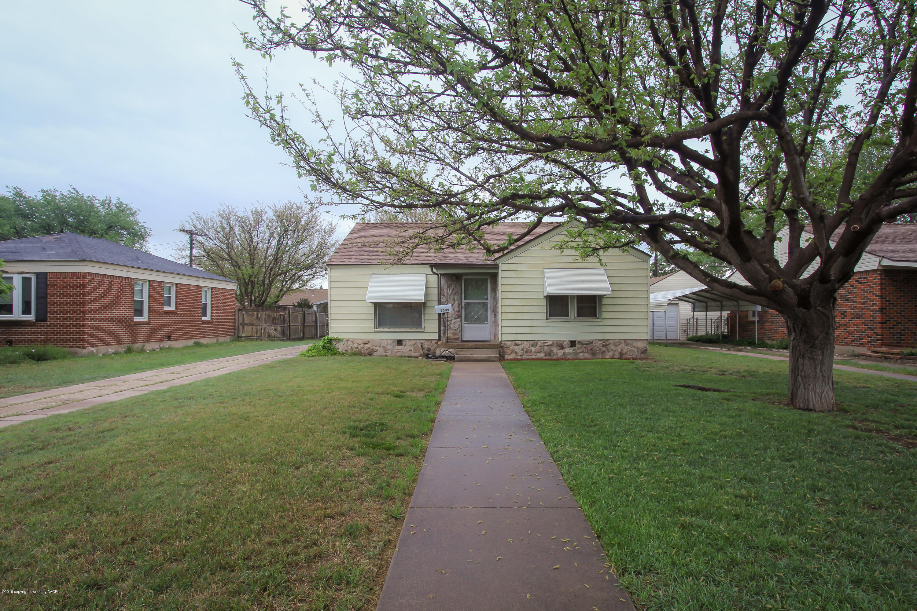 3609 South Lipscomb Street Amarillo, TX 79110 - Photo 2 of 28 a front view of a house with a yard and trees