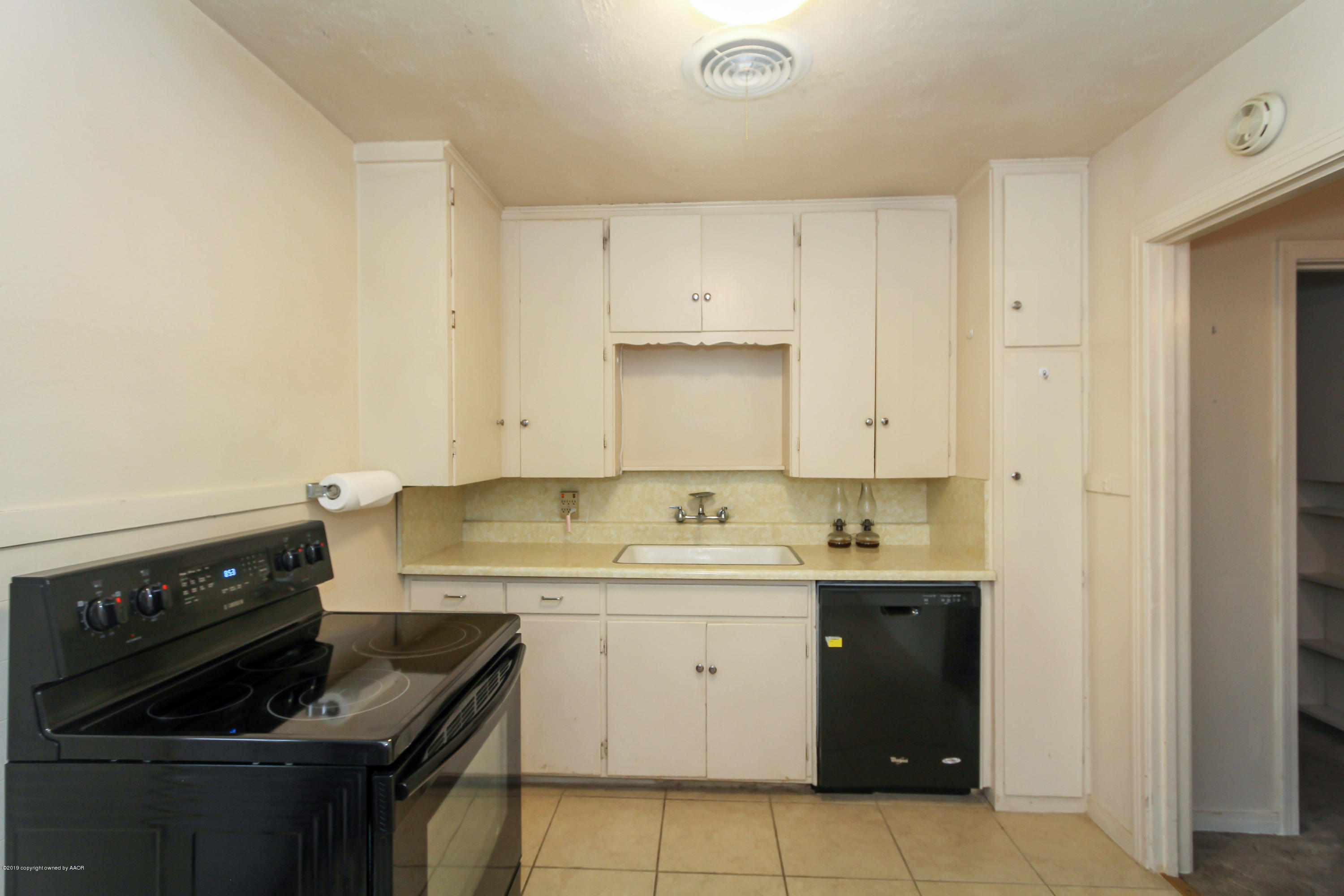 3609 South Lipscomb Street Amarillo, TX 79110 - Photo 11 of 28 a kitchen with a stove sink and cabinets