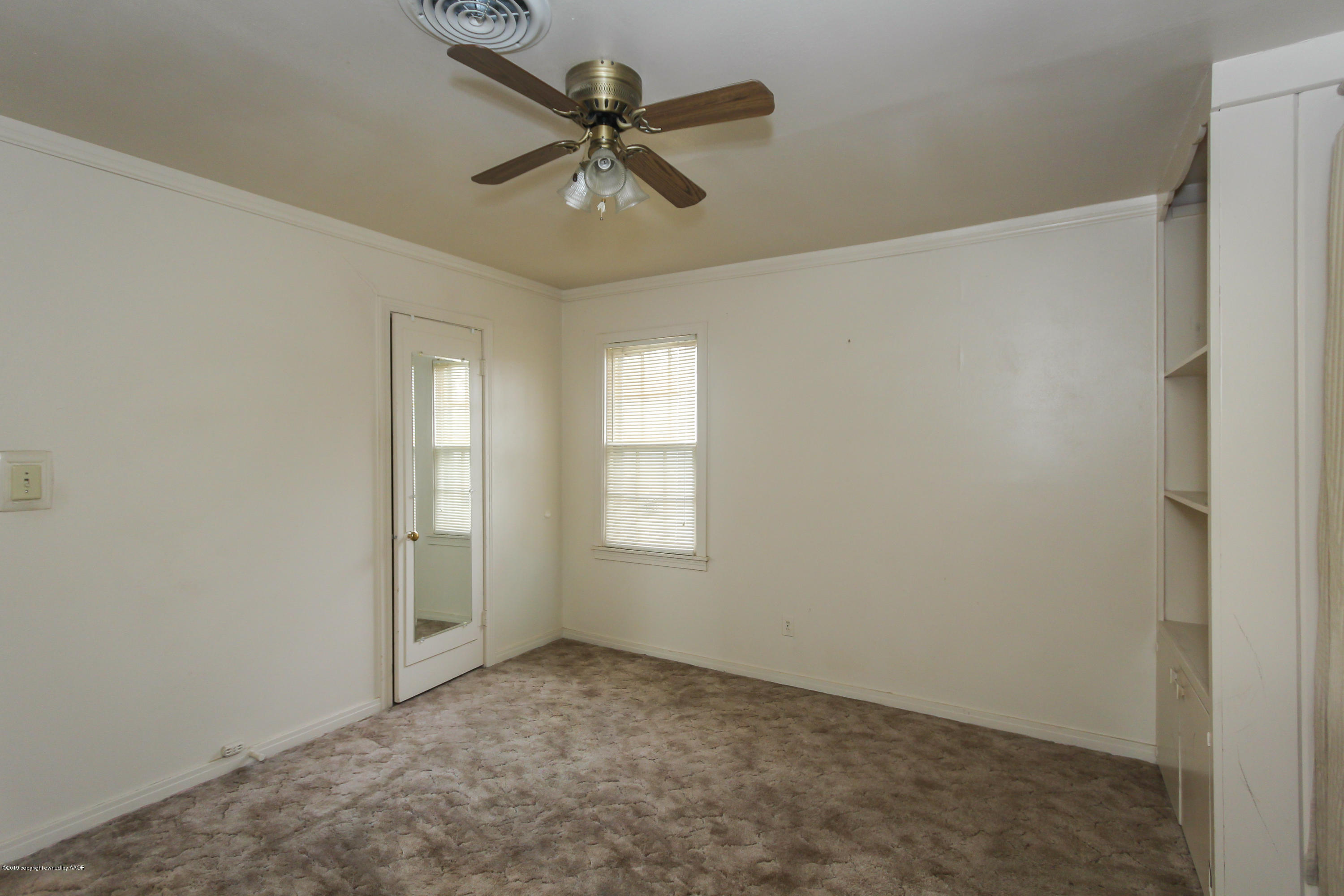 3609 South Lipscomb Street Amarillo, TX 79110 - Photo 18 of 28 an empty room with a window and a fan