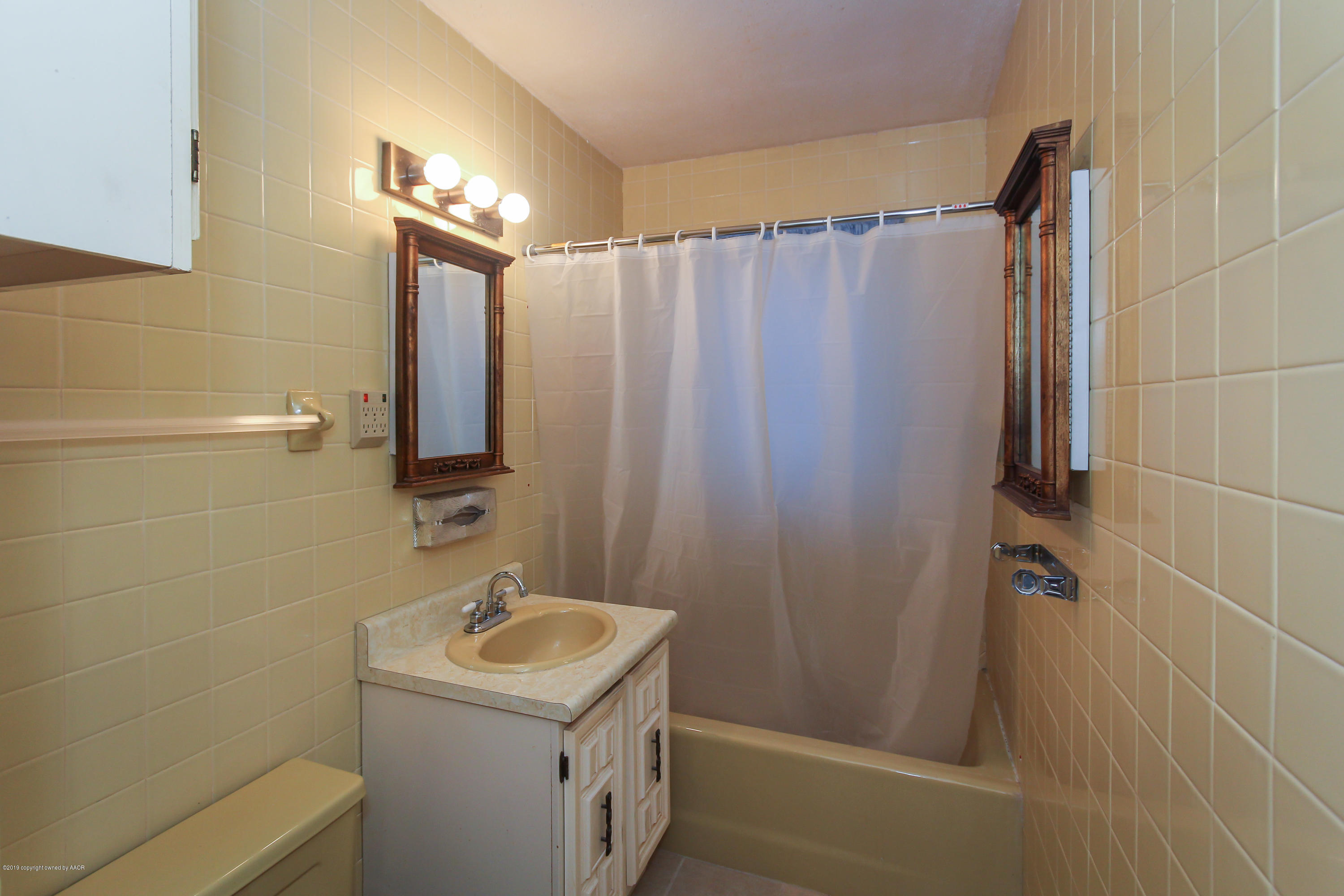 3609 South Lipscomb Street Amarillo, TX 79110 - Photo 20 of 28 a bathroom with a sink a mirror and a shower