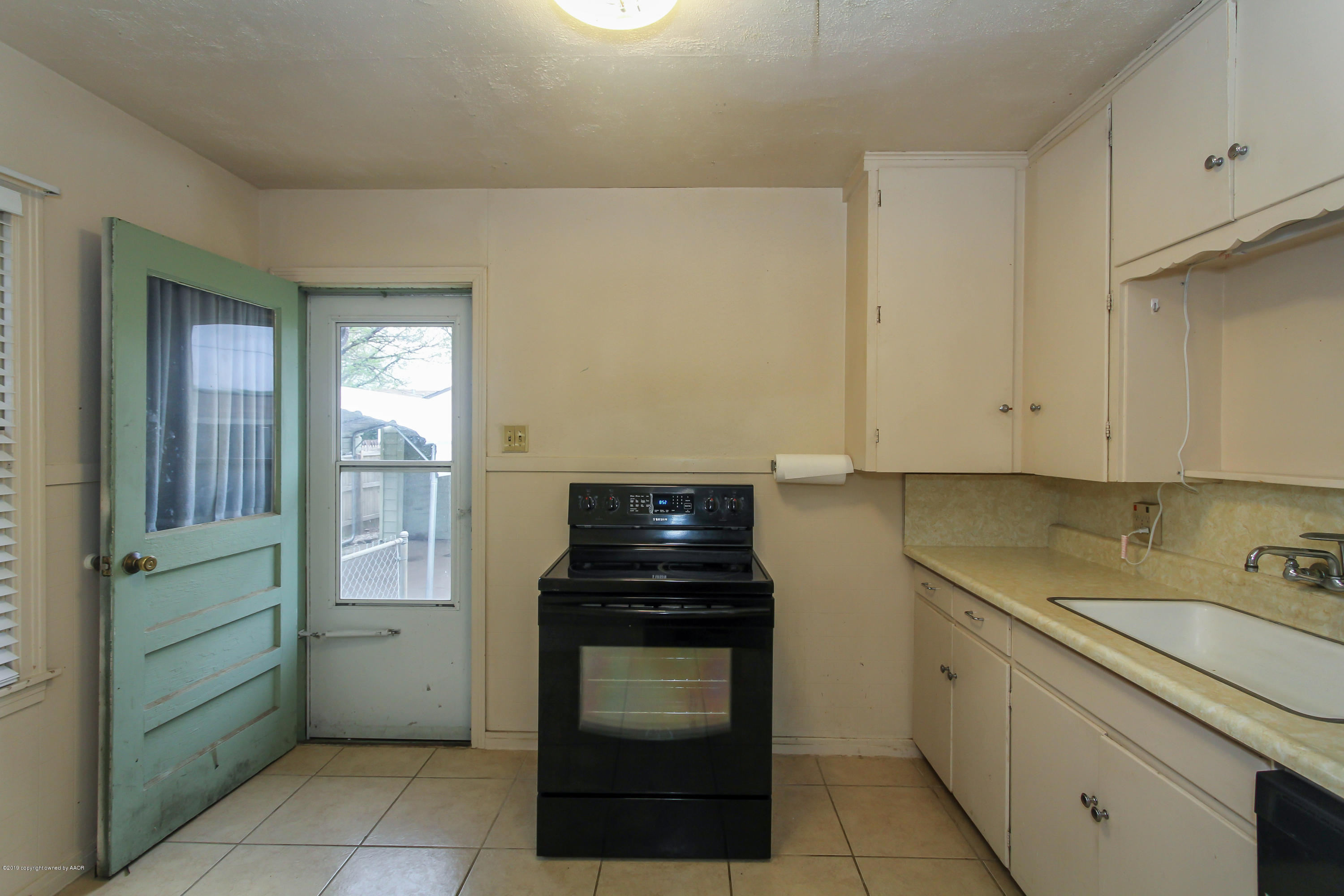 3609 South Lipscomb Street Amarillo, TX 79110 - Photo 9 of 28 a kitchen with a cabinets and white appliances