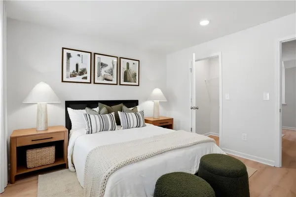 a bedroom with a bed and a lamp