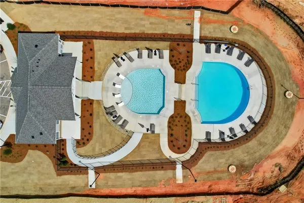 a view of a swimming pool and lounge chairs