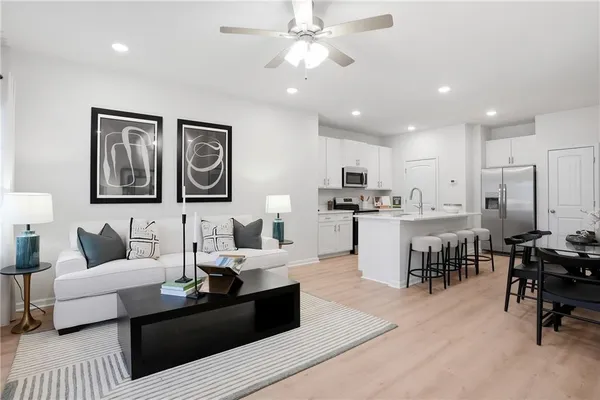 a living room with furniture and kitchen view