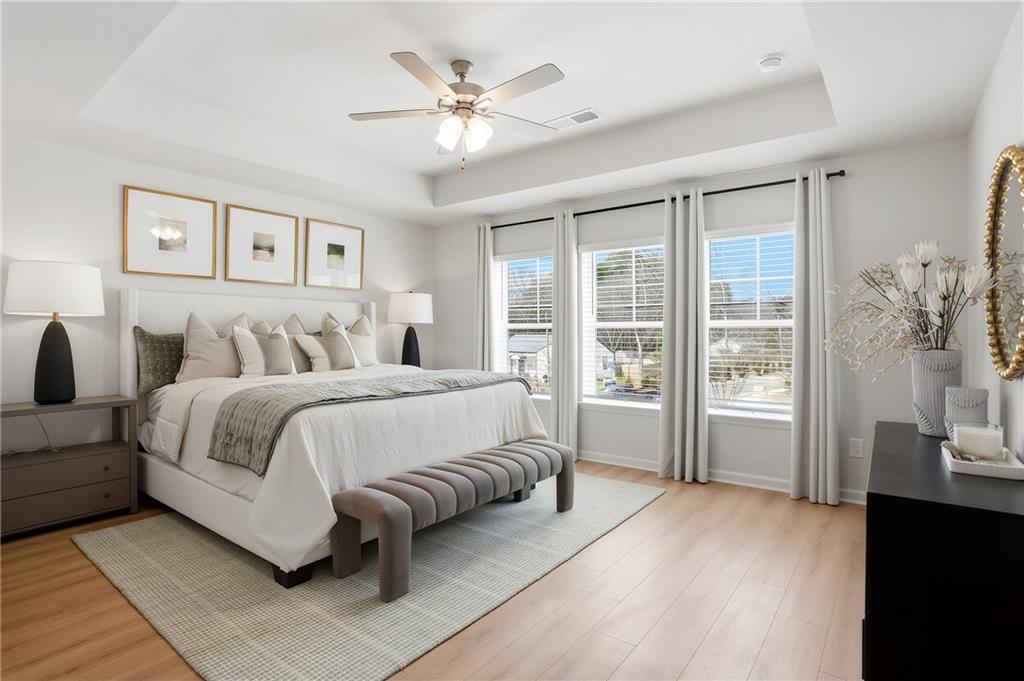 205 Harrell Way Fayetteville, GA 30215 - Photo 6 of 20 a spacious bedroom with a large bed and a chandelier