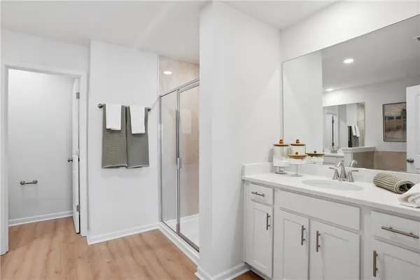 a bathroom with a double vanity sink mirror and shower