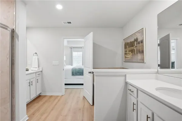 a spacious bathroom with a sink and a mirror