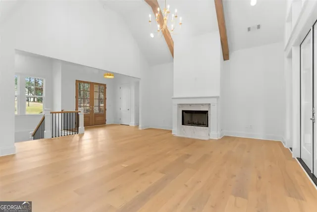 a large kitchen with cabinets and wooden floor