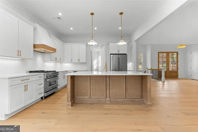 a kitchen with white cabinets and appliances
