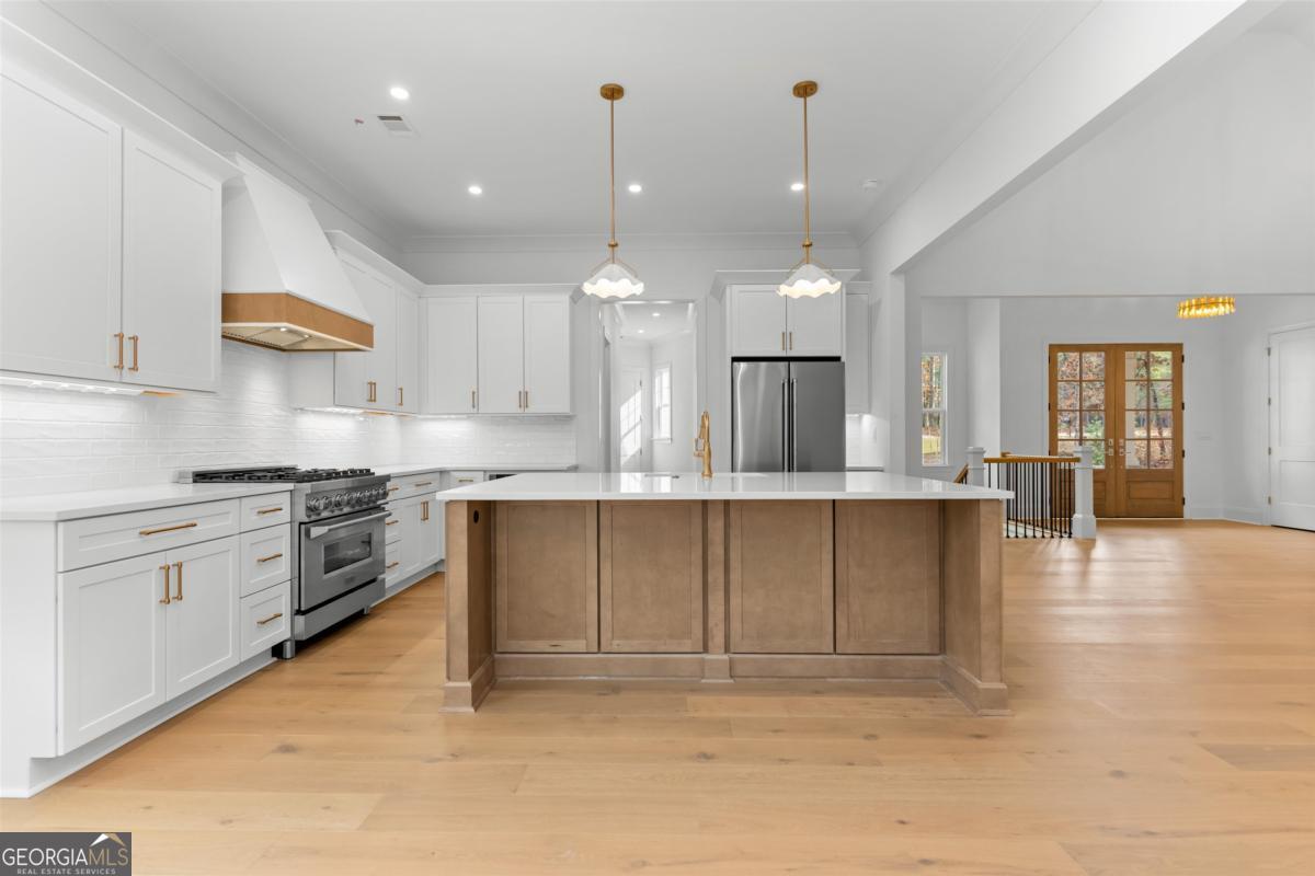 103 Mags Path Eatonton, GA 31024 - Photo 14 of 66 a large kitchen with cabinets and wooden floor