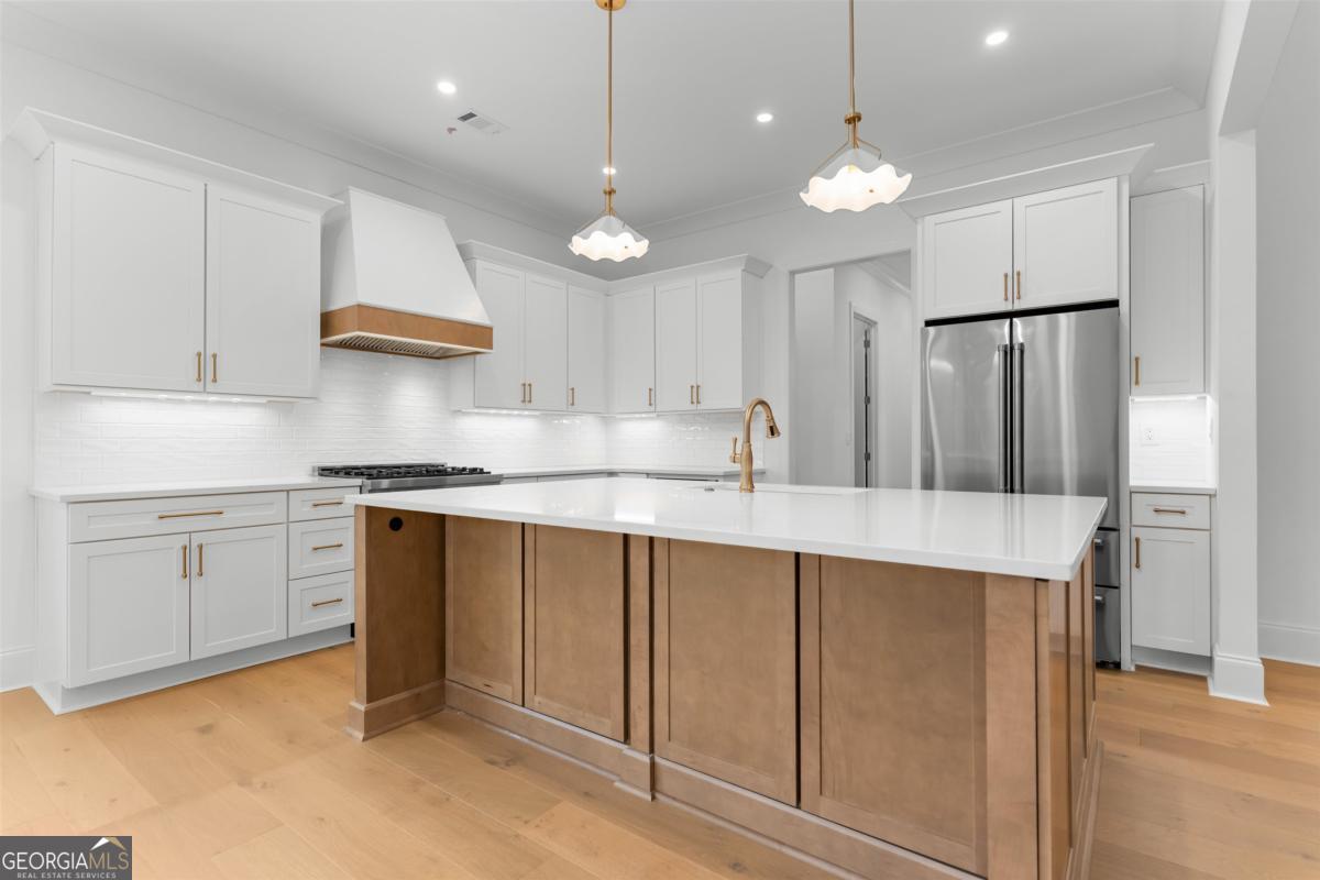 103 Mags Path Eatonton, GA 31024 - Photo 15 of 66 a kitchen with kitchen island a sink stainless steel appliances and cabinets
