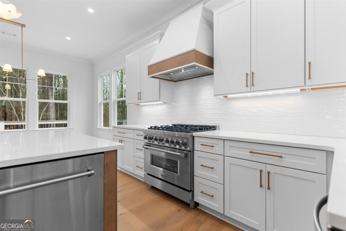 103 Mags Path Eatonton, GA 31024 - Photo 17 of 66 a kitchen with white cabinets and appliances