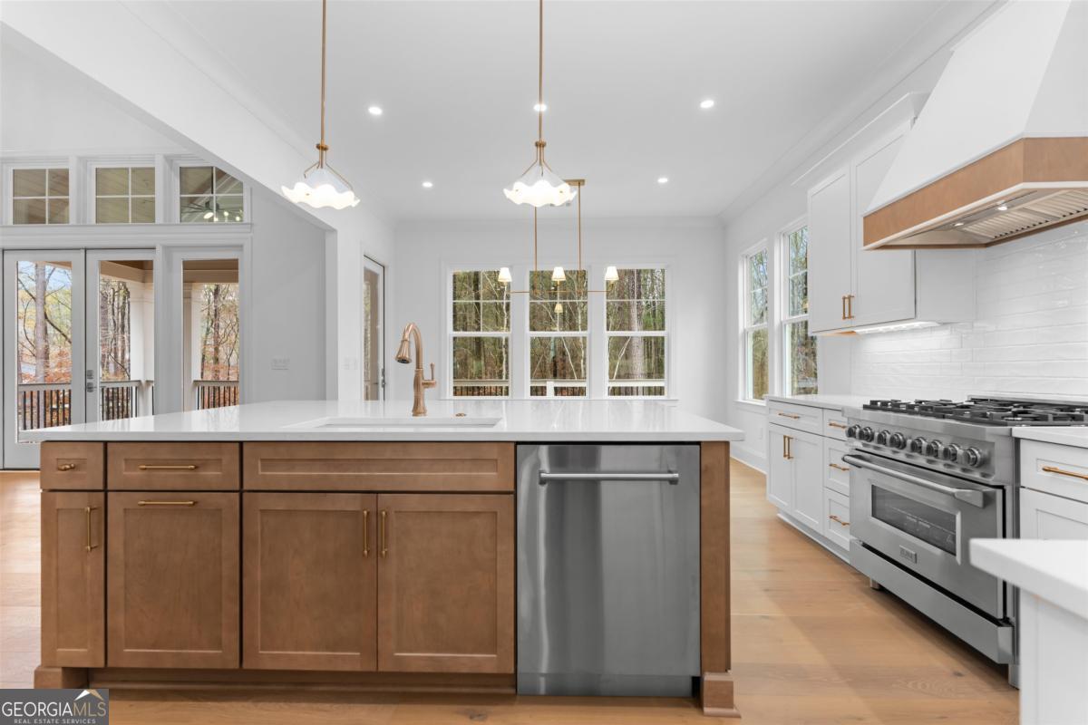 103 Mags Path Eatonton, GA 31024 - Photo 18 of 66 a kitchen with stainless steel appliances granite countertop a stove and a sink