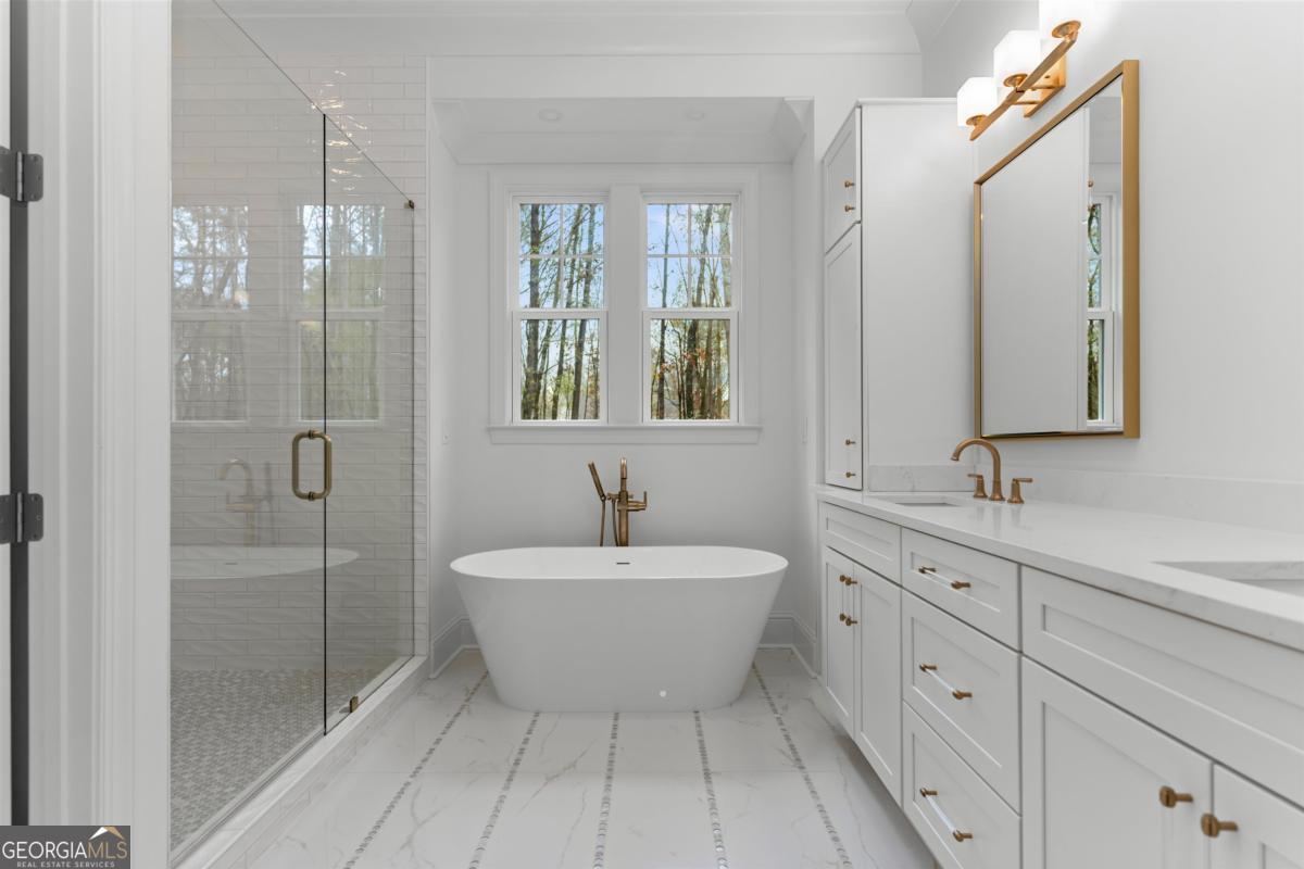 103 Mags Path Eatonton, GA 31024 - Photo 30 of 66 a spacious bathroom with a shower sink and mirror