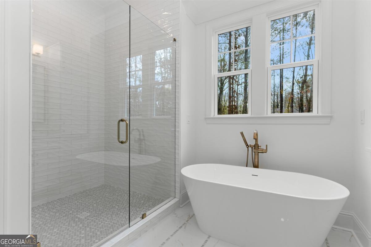 103 Mags Path Eatonton, GA 31024 - Photo 31 of 66 a white bath tub sitting next to a shower