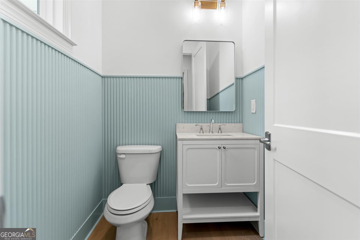 103 Mags Path Eatonton, GA 31024 - Photo 34 of 66 a bathroom with a toilet a sink and mirror