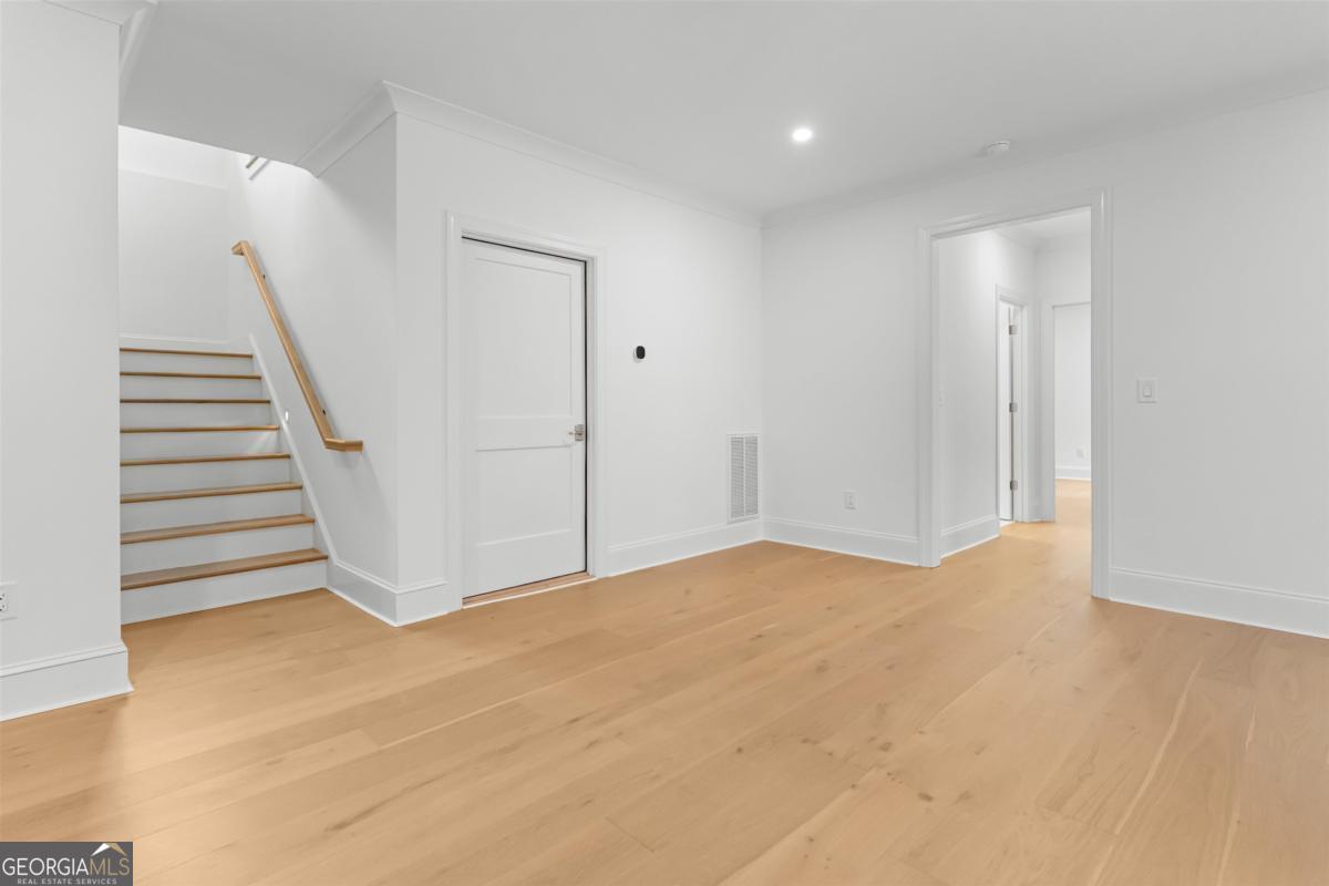 103 Mags Path Eatonton, GA 31024 - Photo 38 of 66 a view of an empty room with wooden floor and stairs