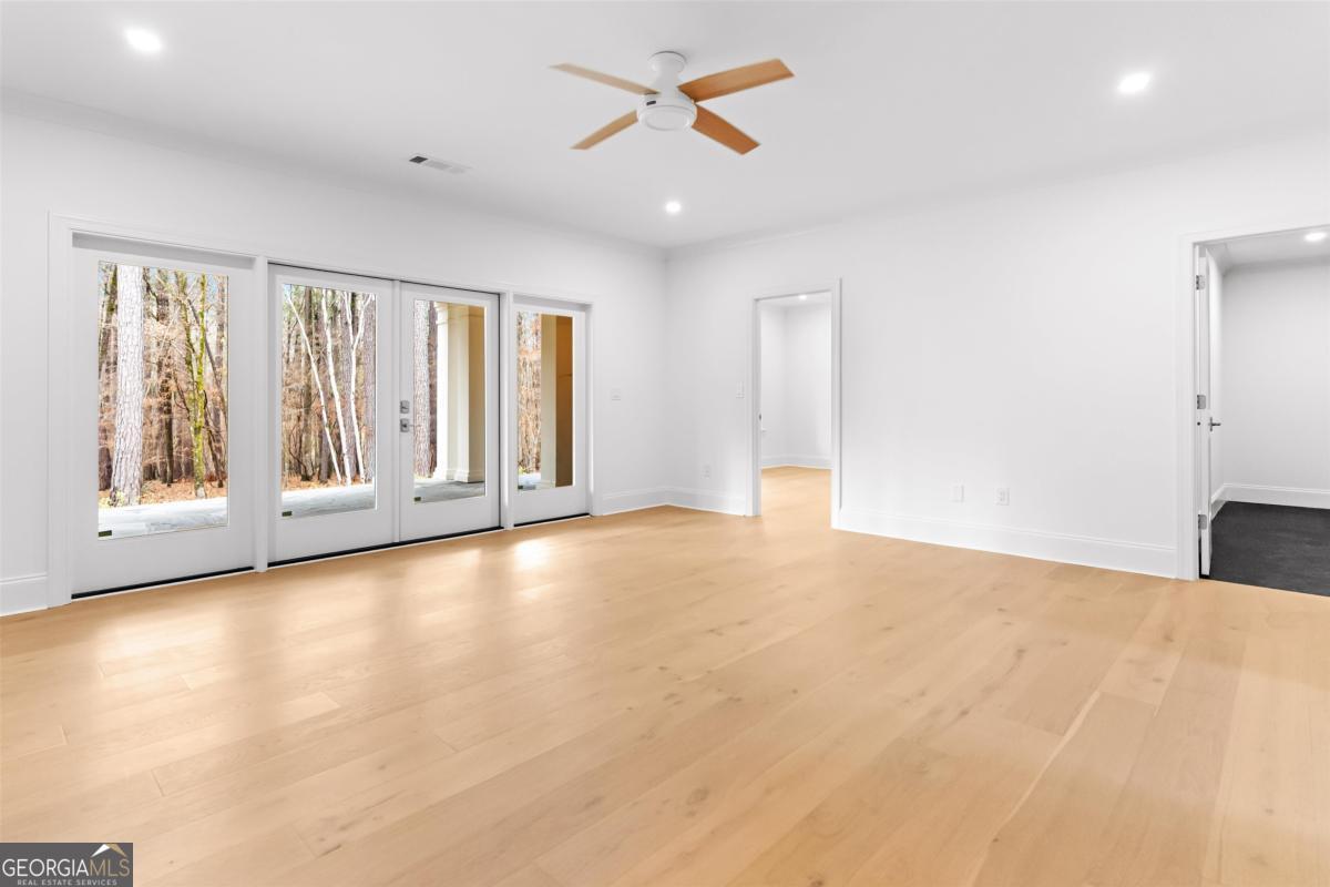 103 Mags Path Eatonton, GA 31024 - Photo 39 of 66 a view of an empty room with a window and a kitchen