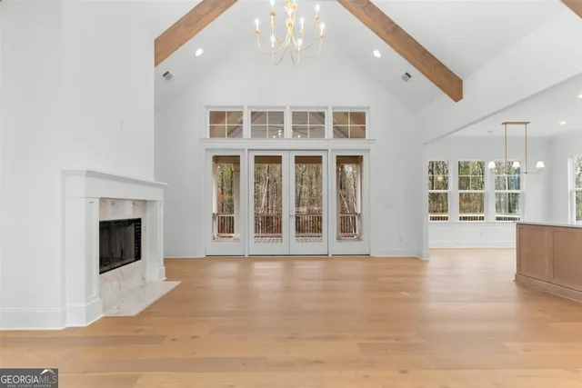 a view of an empty room with a fireplace and a window