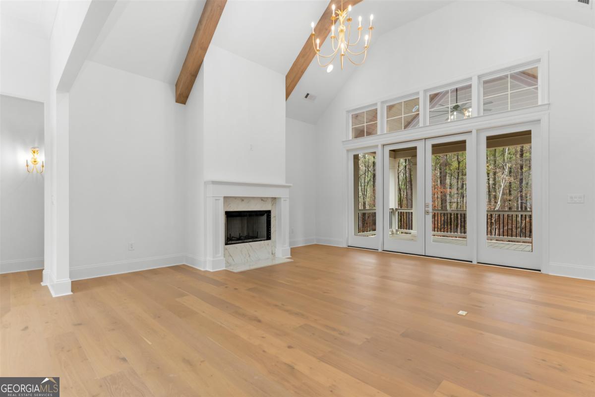 103 Mags Path Eatonton, GA 31024 - Photo 9 of 66 a view of an empty room with a fireplace and a window