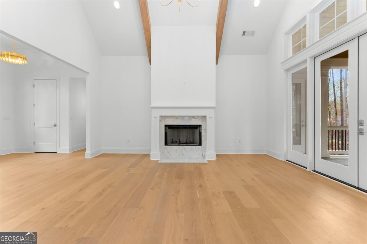 103 Mags Path Eatonton, GA 31024 - Photo 10 of 66 a view of an empty room with a fireplace and a window