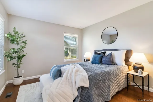 a bedroom with bed and a potted plant