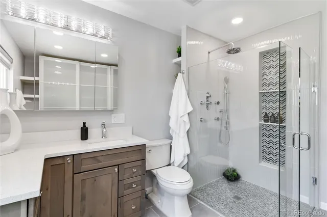 a bathroom with a sink toilet and shower